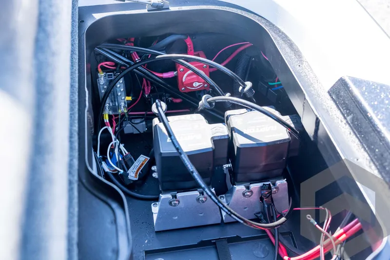 Slide: The Image of 2026 Skeeter ZXE21 boat battery compartment with wiring and components. - 75