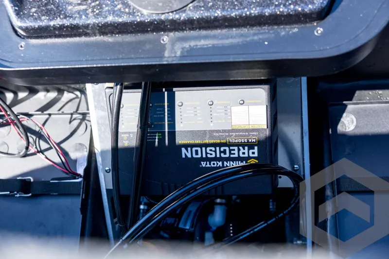 Slide: The Image of 2026 Skeeter ZXE21 boat battery compartment with Minn Kota Precision charger. - 76