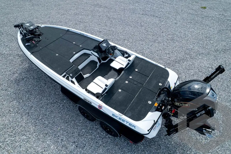 Slide: The Image of 2026 Skeeter ZXE21 fishing boat with dual seats and Yamaha motor on gravel surface. - 80