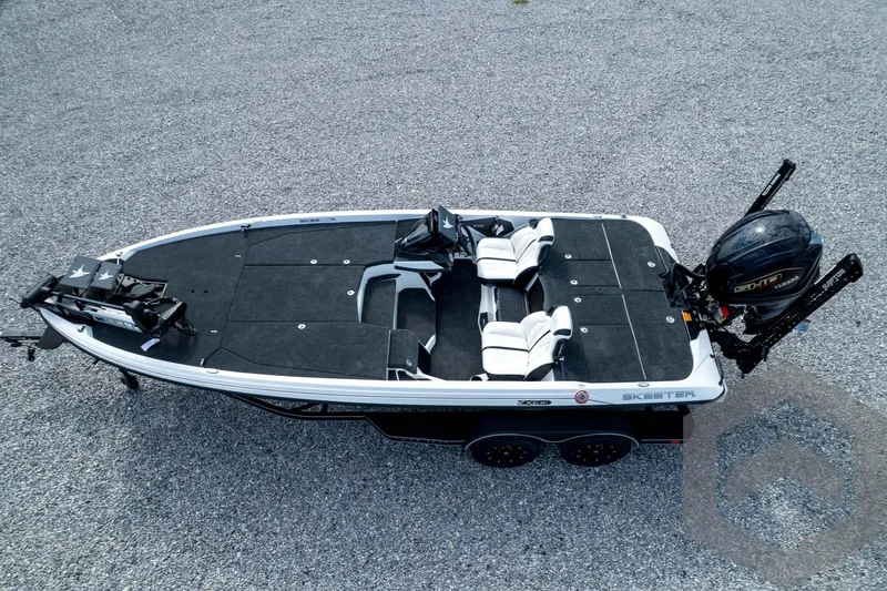 Slide: The Image of 2026 Skeeter ZXE21 fishing boat on gravel, featuring dual seats and powerful outboard motor. - 81
