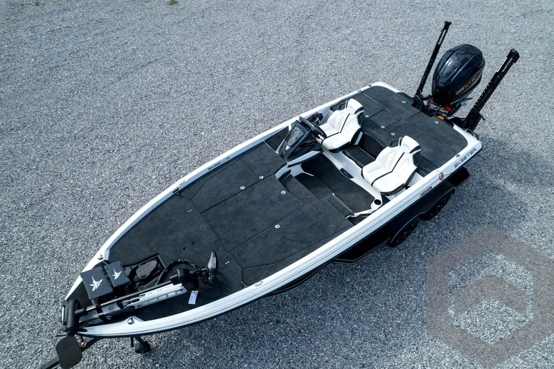 Slide: The Image of 2026 Skeeter ZXE21 fishing boat on gravel, featuring dual seats and advanced equipment. - 82