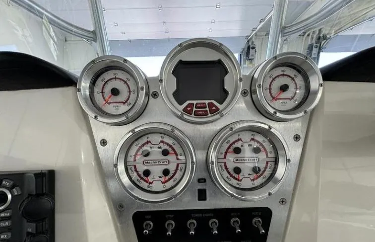 Slide: The Image of Dashboard of 2009 MasterCraft CSX 265 SS boat with gauges and controls. - 13