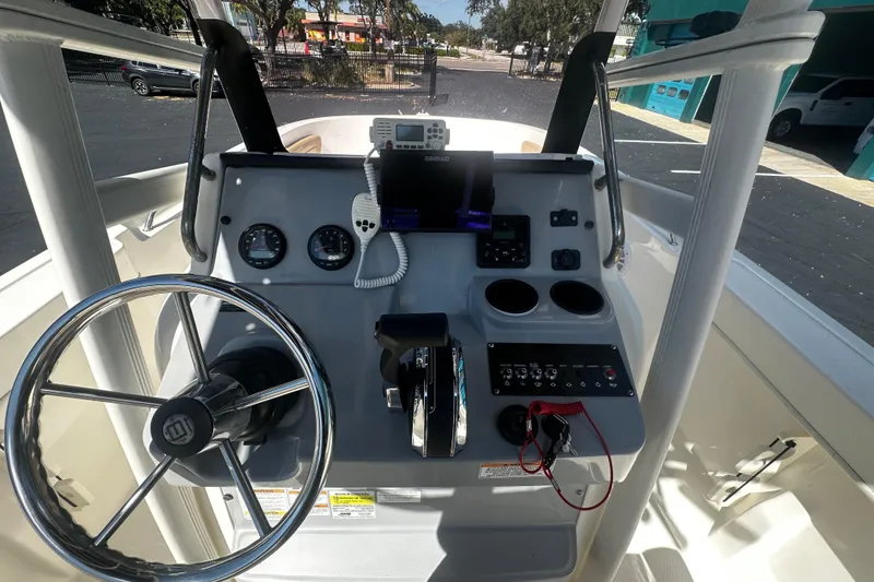Slide: The Image of Control panel of a 2022 Trophy T22 boat with steering wheel and navigation instruments. - 10