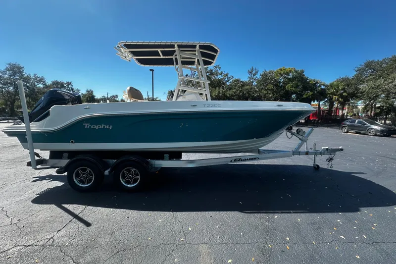 Slide: The Image of 2022 Trophy T22 boat on trailer under clear blue sky. - 2
