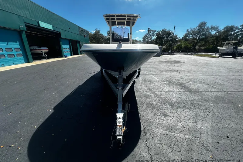 Slide: The Image of 2022 Trophy T22 boat on trailer outside a marine garage under clear blue sky. - 3