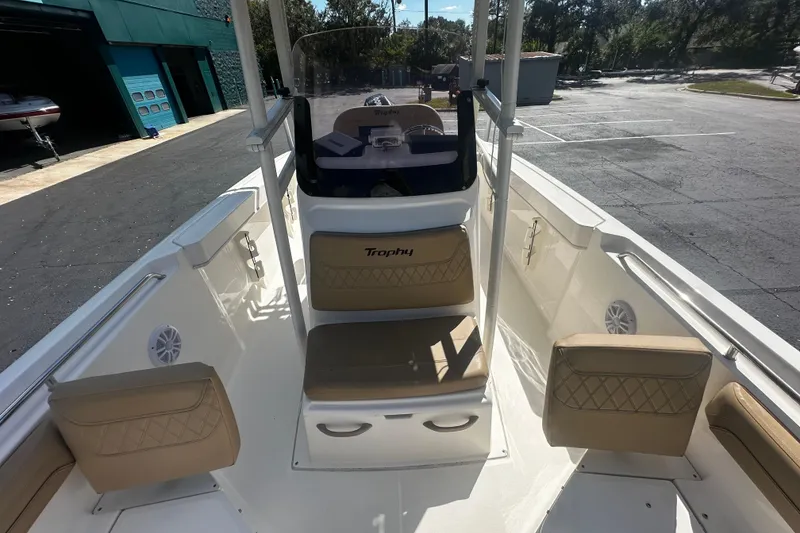 Slide: The Image of 2022 Trophy T22 boat interior with tan seating and steering console. - 8