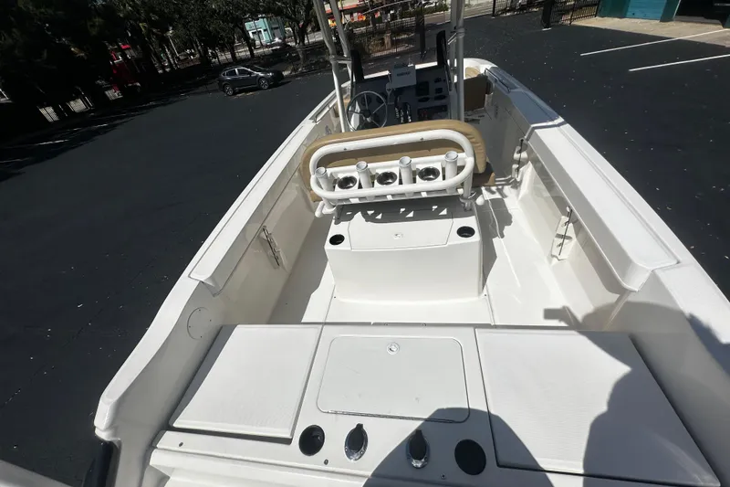 Slide: The Image of 2022 Trophy T22 boat interior with seating and control panel in a parking lot. - 9