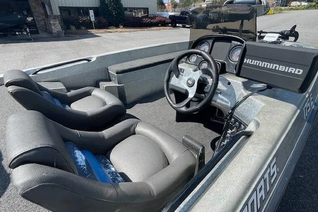 Slide: The Image of 1996 Hydra-Sports 175E boat interior with steering wheel and Humminbird fish finder. - 5