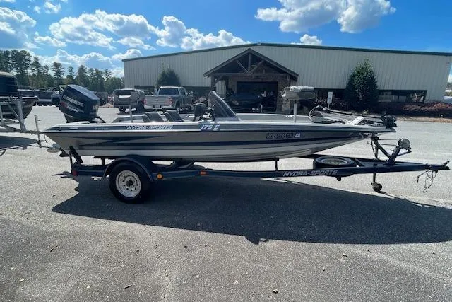 Slide: The Image of 1996 Hydra-Sports 175E boat on trailer, parked outdoors under a blue sky. - 6