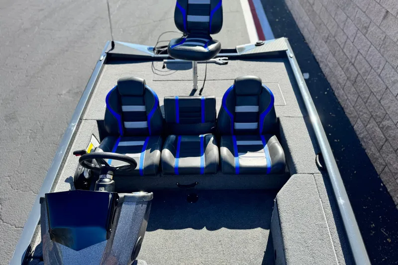 Slide: The Image of 2021 Ranger RT178 boat interior with blue-accented seats and steering console. - 10