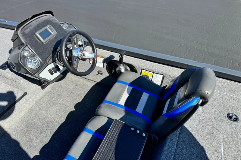 Slide: The Image of 2021 Ranger RT178 boat cockpit with steering wheel and blue-accented seat. - 15