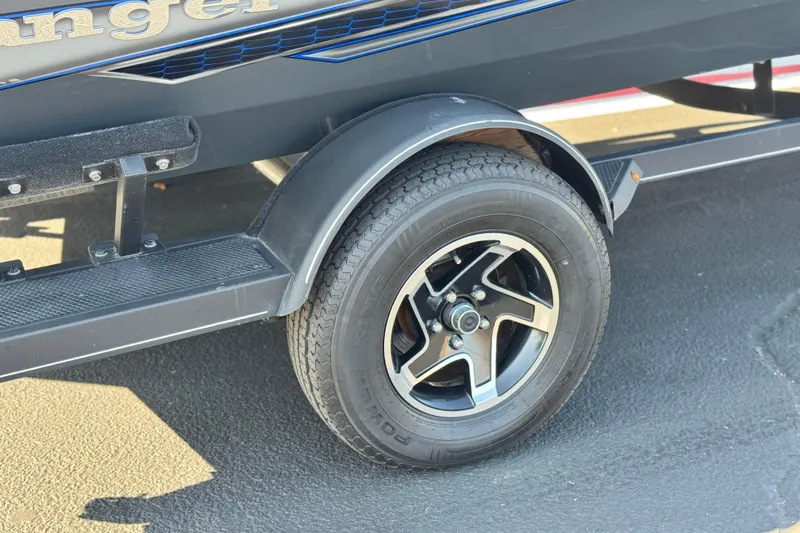 Slide: The Image of 2021 Ranger RT178 trailer wheel with black alloy rim on asphalt surface. - 17