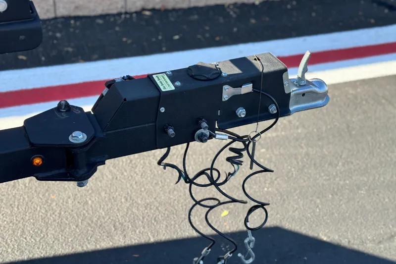 Slide: The Image of Trailer hitch of a 2021 Ranger RT178 boat, featuring safety chains and wiring. - 19