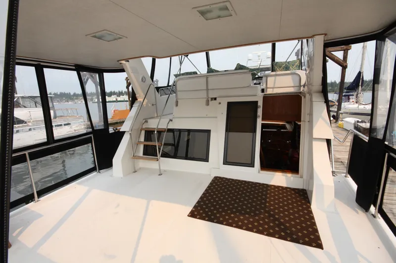 Slide: The Image of 1989 Ocean Alexander 420 Cockpit Motor Yacht interior with spacious deck and marina view. - 11