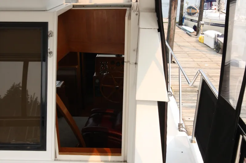 Slide: The Image of 1989 Ocean Alexander 420 Cockpit Motor Yacht interior view with dockside access. - 12