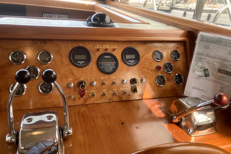 Slide: The Image of Control panel of a 1989 Ocean Alexander 420 Cockpit Motor Yacht with gauges and levers. - 15