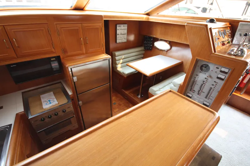 Slide: The Image of 1989 Ocean Alexander 420 Cockpit Motor Yacht interior with kitchen and dining area. - 21