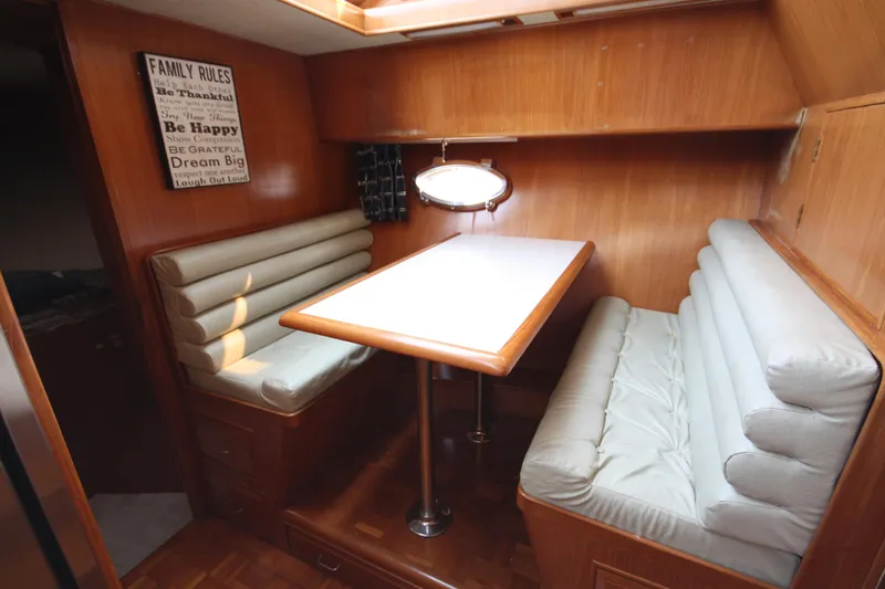Slide: The Image of 1989 Ocean Alexander 420 Cockpit Motor Yacht interior dining area with cushioned seating. - 24