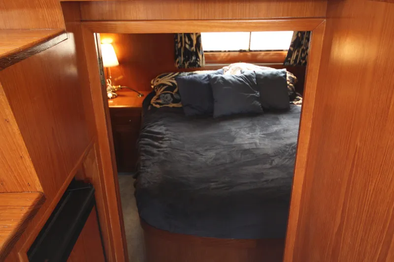 Slide: The Image of Cozy bedroom in 1989 Ocean Alexander 420 Cockpit Motor Yacht with wooden interior. - 28
