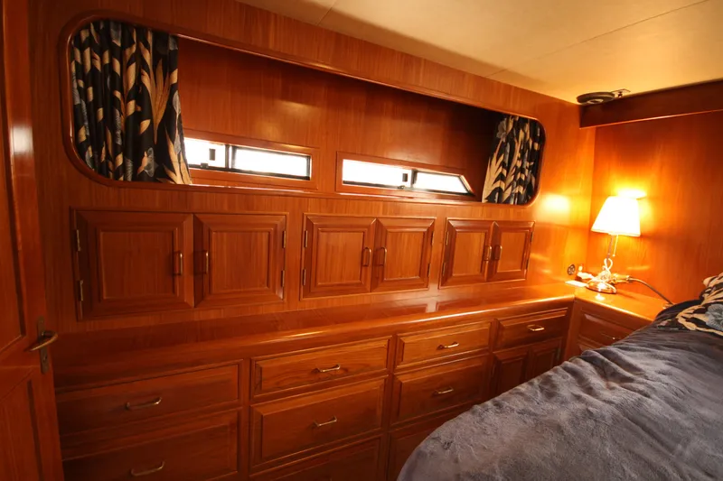 Slide: The Image of Luxurious wooden interior of 1989 Ocean Alexander 420 Cockpit Motor Yacht cabin. - 31