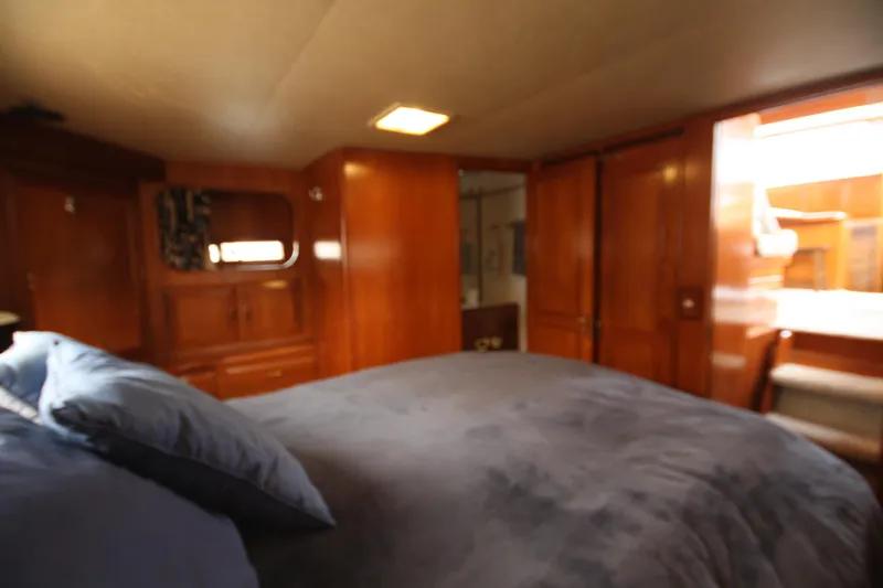 Slide: The Image of Luxurious cabin interior of 1989 Ocean Alexander 420 Cockpit Motor Yacht with wooden finishes. - 33