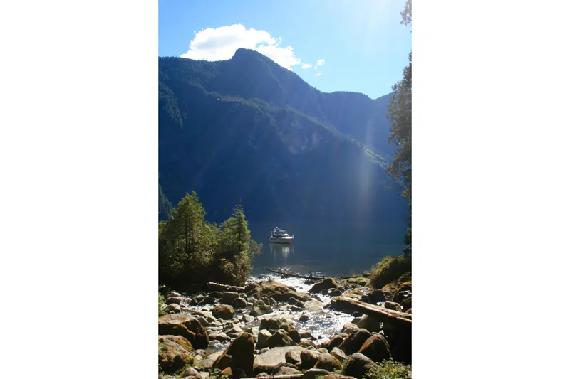 Slide: The Image of Ocean Alexander 420 Cockpit Motor Yacht on serene lake with mountainous backdrop, 1989 model. - 48
