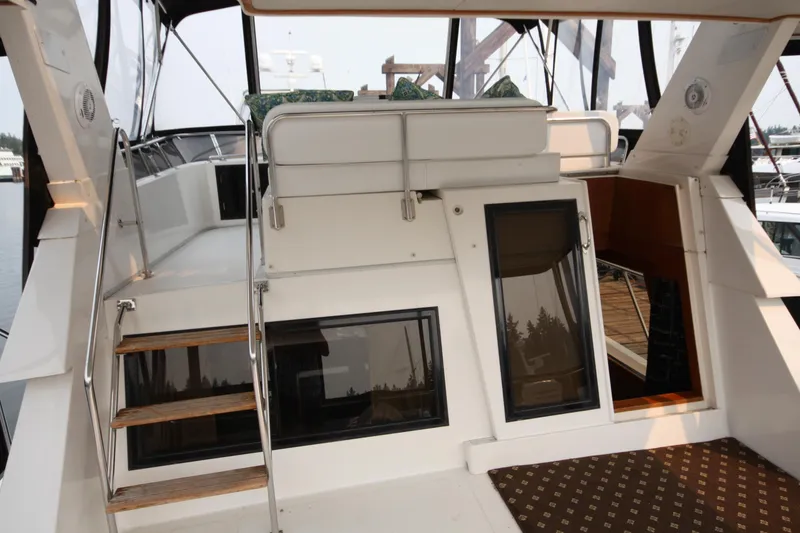 Slide: The Image of 1989 Ocean Alexander 420 Cockpit Motor Yacht interior with stairs and seating area. - 5
