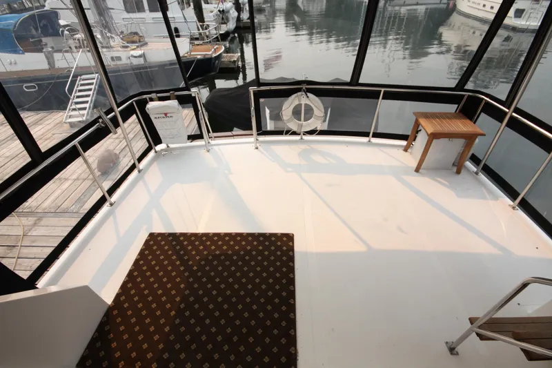 Slide: The Image of 1989 Ocean Alexander 420 Cockpit Motor Yacht deck with table and safety equipment. - 6