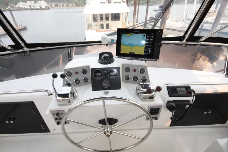 Slide: The Image of Cockpit view of 1989 Ocean Alexander 420 Motor Yacht with navigation equipment and steering wheel. - 9