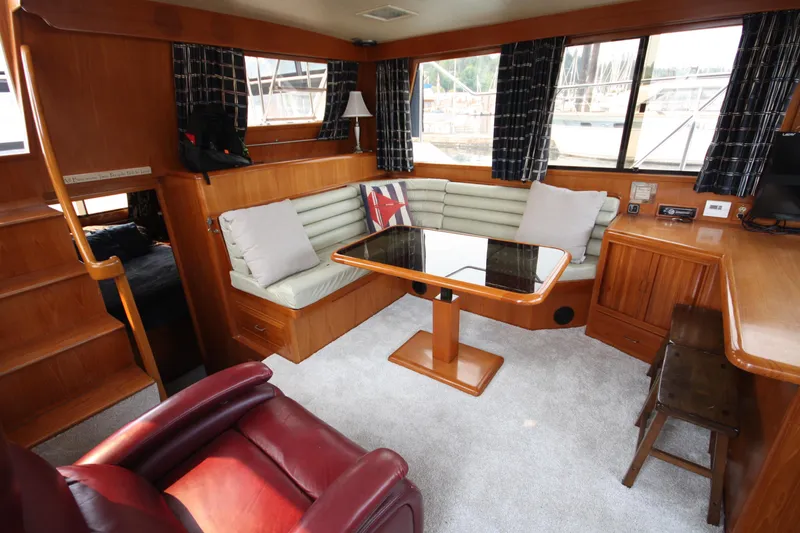 Slide: The Image of 1989 Ocean Alexander 420 Cockpit Motor Yacht interior with wood finish and seating area. - 19