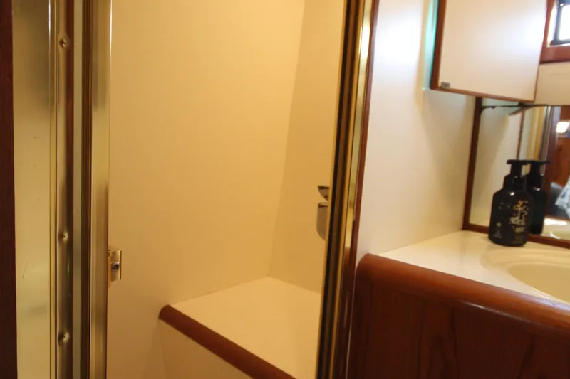 Slide: The Image of Bathroom interior of 1989 Ocean Alexander 420 Cockpit Motor Yacht, featuring sink and mirror. - 27