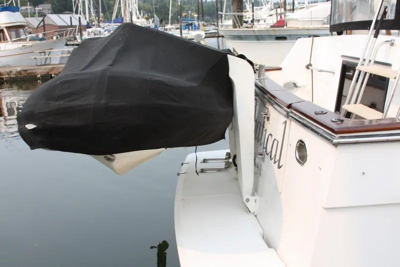 Slide: The Image of 1989 Ocean Alexander 420 Cockpit Motor Yacht docked, featuring covered equipment on the stern. - 45