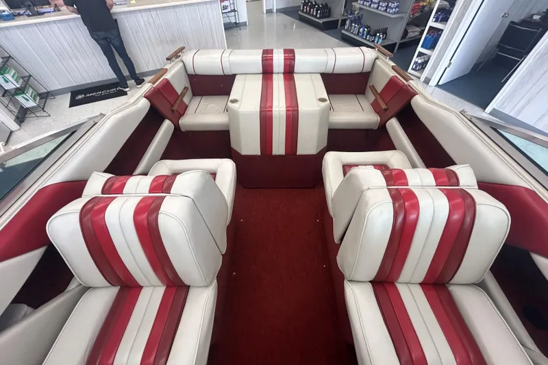 Slide: The Image of 1987 Sea Ray 19 Seville Cuddy Cabin interior with red and white striped seating. - 10
