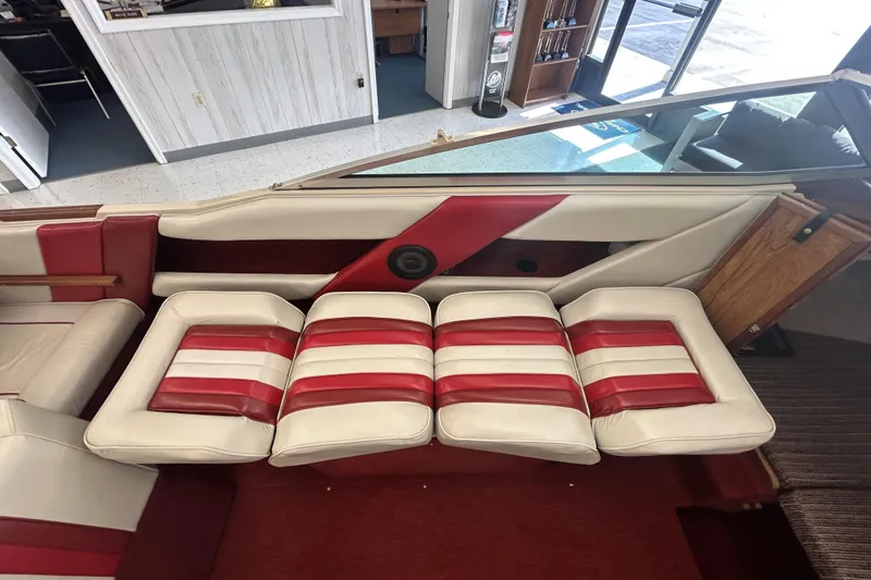 Slide: The Image of 1987 Sea Ray 19 Seville Cuddy Cabin interior with red and white striped seating. - 11
