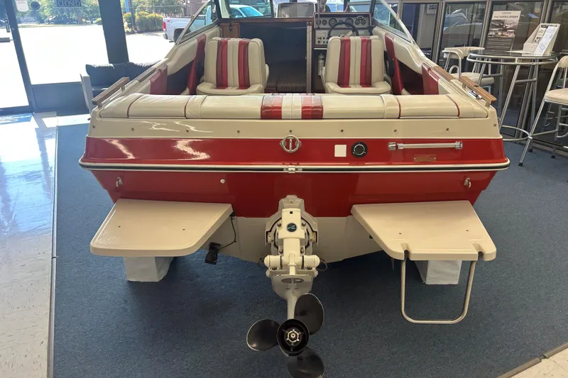 Slide: The Image of 1987 Sea Ray 19 Seville Cuddy Cabin boat with red and white interior, rear view. - 2