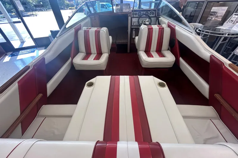 Slide: The Image of 1987 Sea Ray 19 Seville Cuddy Cabin interior with red and white seating. - 6