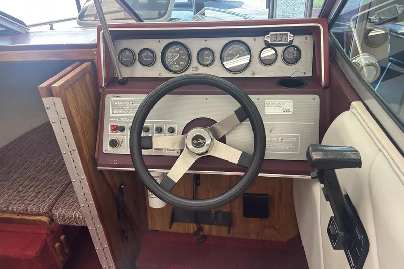 Slide: The Image of 1987 Sea Ray 19 Seville Cuddy Cabin dashboard with steering wheel and gauges. - 7