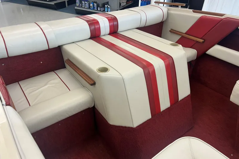 Slide: The Image of 1987 Sea Ray 19 Seville Cuddy Cabin interior with red and white seating. - 8