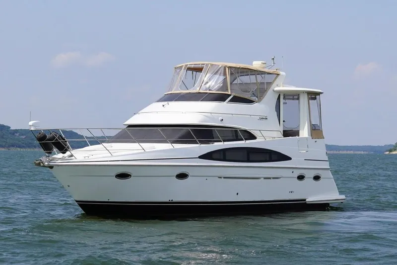 Slide: The Image of 2003 Carver 396 Motor Yacht cruising on open water, front view. - 11