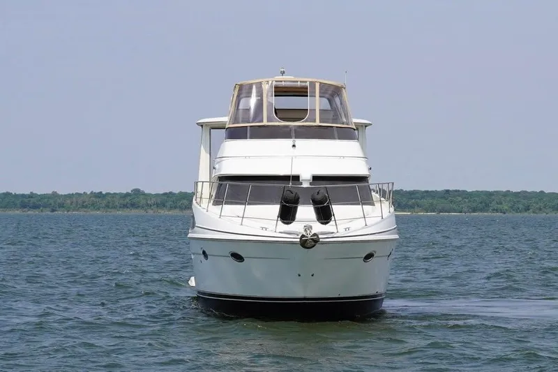 Slide: The Image of 2003 Carver 396 Motor Yacht cruising on open water under a clear sky. - 12