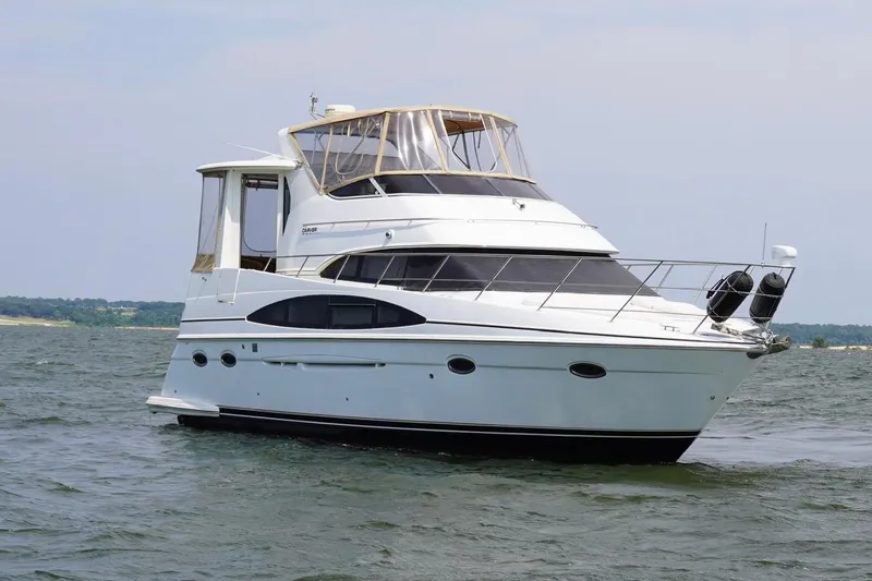 Slide: The Image of 2003 Carver 396 Motor Yacht on water, rear view with American flag. - 14