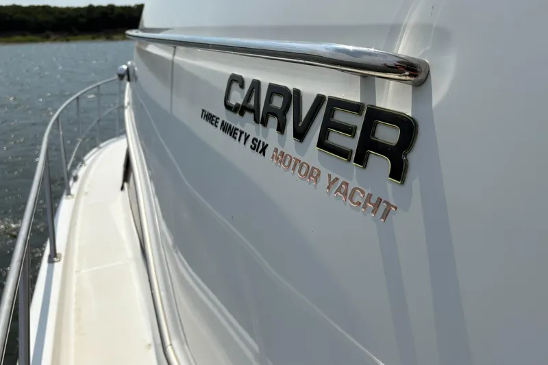 Slide: The Image of 2003 Carver 396 Motor Yacht on water, showcasing sleek design and branding. - 16