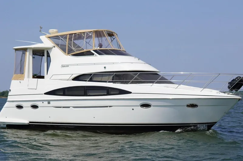Slide: The Image of 2003 Carver 396 Motor Yacht cruising on open water, showcasing sleek design and luxury features. - 2