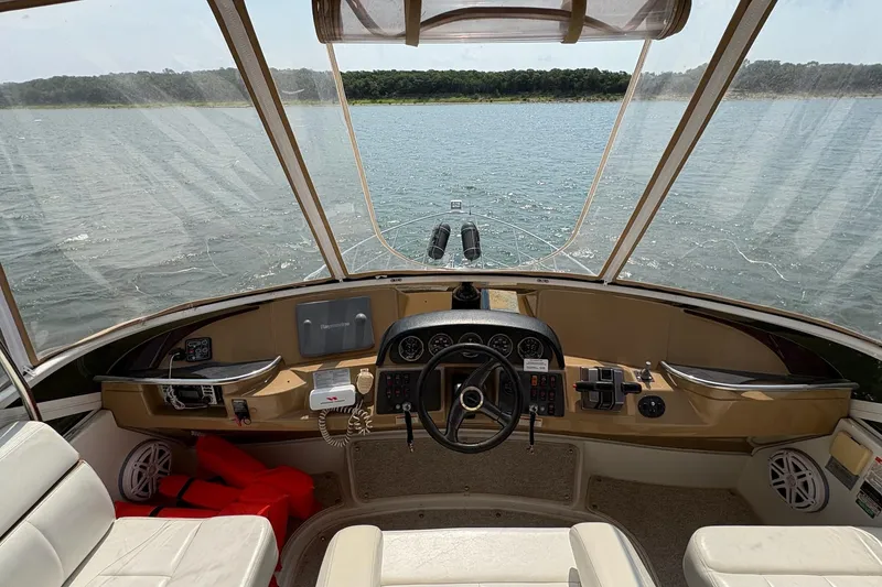 Slide: The Image of Bow view of 2003 Carver 396 Motor Yacht cruising on a calm lake. - 24
