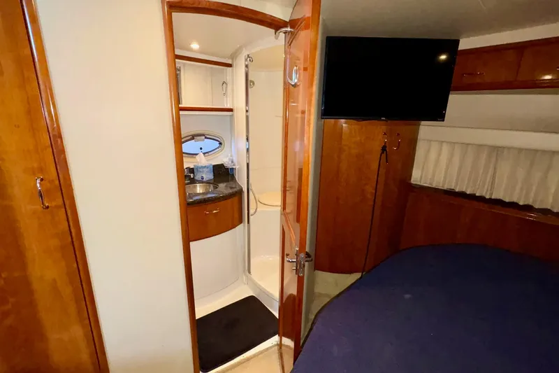 Slide: The Image of 2003 Carver 396 Motor Yacht bathroom with shower, sink, and porthole window. - 37