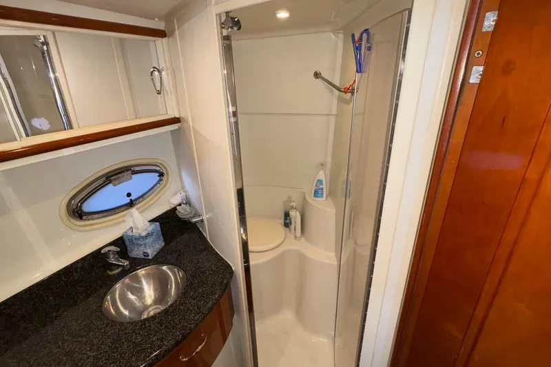 Slide: The Image of Luxurious bathroom in 2003 Carver 396 Motor Yacht with granite countertop and porthole windows. - 38