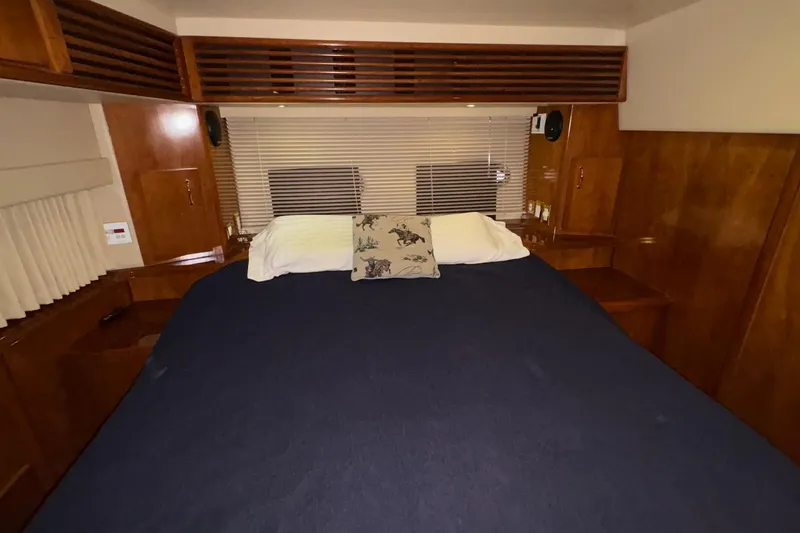 Slide: The Image of 2003 Carver 396 Motor Yacht interior with wooden cabinetry and cozy seating area. - 40