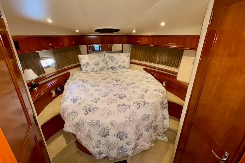 Slide: The Image of Luxurious bedroom in 2003 Carver 396 Motor Yacht with coral-patterned bedding. - 44