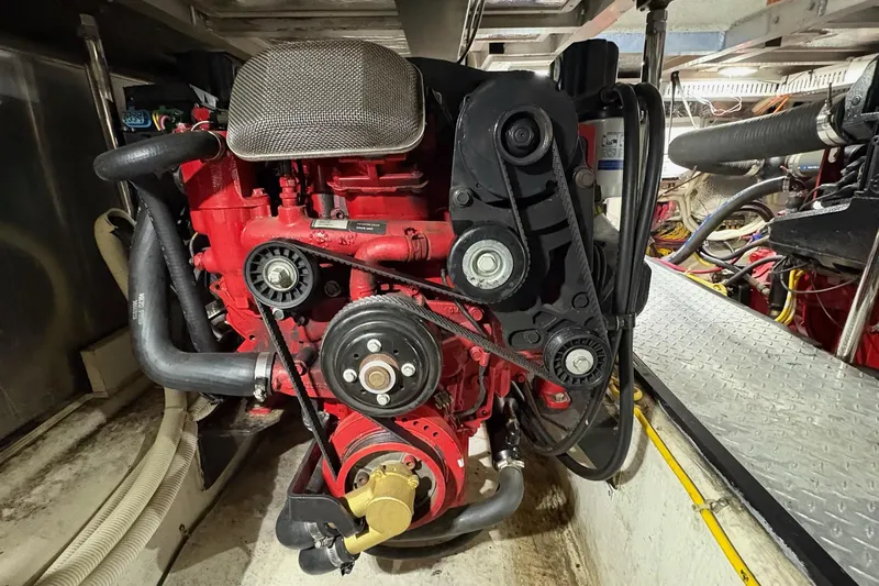 Slide: The Image of Engine room of a 2003 Carver 396 Motor Yacht with visible machinery and fire extinguisher. - 54