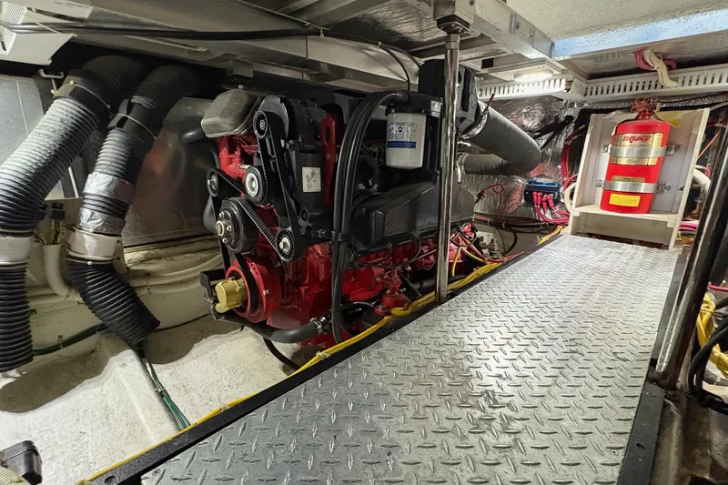 Slide: The Image of Engine compartment of a 2003 Carver 396 Motor Yacht, showcasing mechanical components. - 55